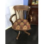 A revolving oak office chair