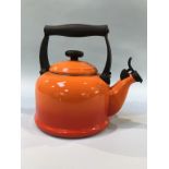 An orange Le Creuset kettle