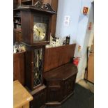 An Old Charm oak long case clock, with TV stand