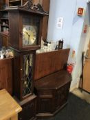 An Old Charm oak long case clock, with TV stand