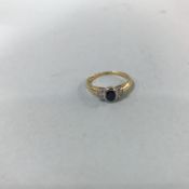 An 18ct gold, yellow diamond and sapphire, three stone rub over ring