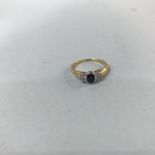 An 18ct gold, yellow diamond and sapphire, three stone rub over ring