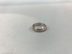 A platinum brushed diamond set wedding ring