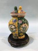 A Chinese lidded vase, decorated in two halves, signed in underglaze red, 18cm height