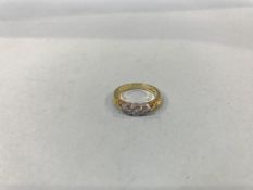 An 18ct gold, fancy three stone diamond ring