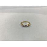 An 18ct gold, fancy three stone diamond ring