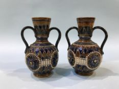 A pair of Doulton Lambeth two handled vases, 16cm height