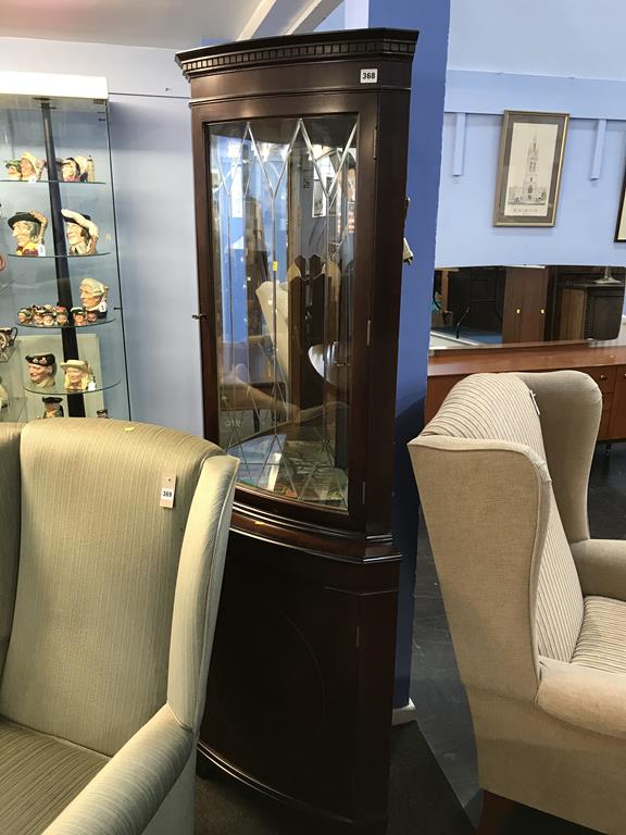 A reproduction mahogany corner cabinet