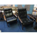 A pair of teak framed and vinyl upholstered 'Cintique' armchairs
