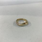 A 9ct gold yellow diamond set twist ring