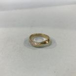 A 9ct gold yellow diamond set twist ring