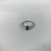 A platinum three stone sapphire and diamond ring