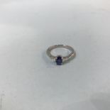 A platinum three stone sapphire and diamond ring