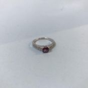 An 18ct gold, white split shank diamond ring, set with central emerald cut ruby