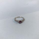 An 18ct gold, white split shank diamond ring, set with central emerald cut ruby