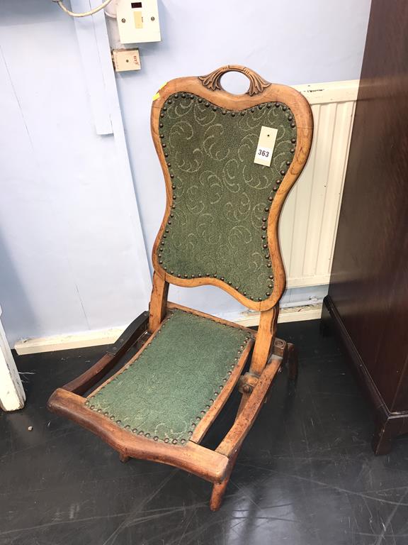 A folding walnut chair