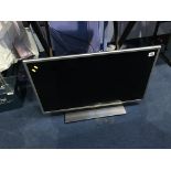 An LG TV, with remote