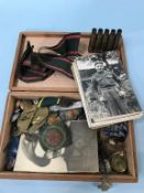 A box of various cap and shoulder badges and buttons etc.