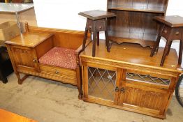An oak cabinet and oak telephone seat