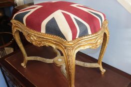 A gilt cross framed stool, with Union Jack pattern seat, 78cm wide