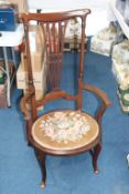 An Edwardian pad foot carver chair