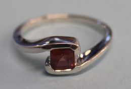A 9ct white gold and garnet ring, size 'N'
