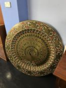 A very large and decorative Indian brass table top, decorated with a central peacock with stylised