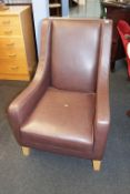 A pair of MultiYork Heritage brown leather armchairs and footstool
