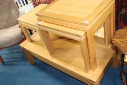 A light oak nest of tables, a coffee table and a smaller table