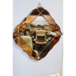 A Deco two colour lozenge shape mirror, 73cm wide