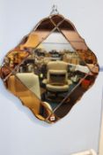 A Deco two colour lozenge shape mirror, 73cm wide