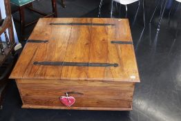 A hardwood square coffee table, with rising top