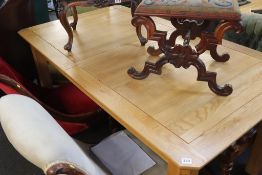 A light oak extending dining table