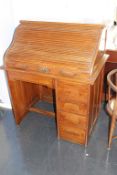 A 1930's small oak tambour desk, with four drawers, 89cm wide