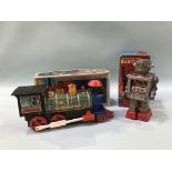 A boxed Japanese battery operated 'Attacking Martian' robot and a boxed 'Pioneer train'