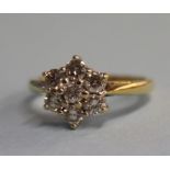 An 18ct gold, seven stone 0.75ct diamond cluster ring, size 'K'
