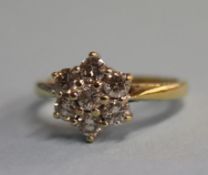 An 18ct gold, seven stone 0.75ct diamond cluster ring, size 'K'