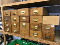 Twenty small wooden filing drawers