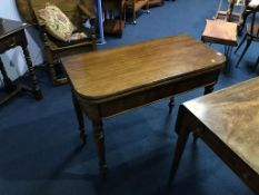 A 19th century mahogany fold over tea table