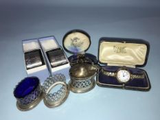 A gold ladies watch and silver napkin rings etc.