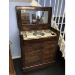 A 19th century mahogany ships wash stand, the rising top opens to reveal a fitted interior, below