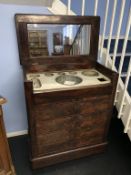 A 19th century mahogany ships wash stand, the rising top opens to reveal a fitted interior, below