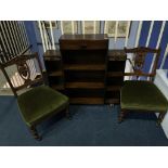 A pair of Edwardian nursing chairs and a small oak bookcase