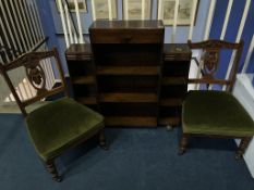 A pair of Edwardian nursing chairs and a small oak bookcase