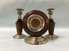 A pair of candle sticks and a clock
