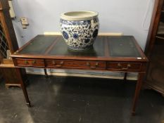 A ladies writing desk with inset leather top, three drawers supported on square tapered legs and