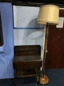 A standard lamp, bookcase and tea trolley