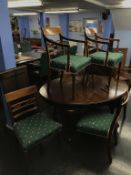 A set of mahogany chairs, comprising of six single and two carvers and an extending dining table