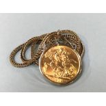 A sovereign, dated 1918, with 9ct gold mount and chain, 14g total