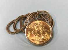 A sovereign, dated 1918, with 9ct gold mount and chain, 14g total
